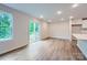 Spacious living room with natural light streaming through windows and sliding glass doors, and wood flooring at 126 Dorian Pl, Troutman, NC 28166