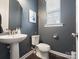 Stylish powder room features a pedestal sink, modern fixtures, and a window at 1305 Kings Grove Dr, York, SC 29745