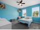 Bright bedroom with blue walls, natural light, ceiling fan and ample space for relaxation and personalization at 1305 Kings Grove Dr, York, SC 29745