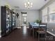 Formal dining room with hardwood floors, modern chandelier, and view to the front yard at 1305 Kings Grove Dr, York, SC 29745