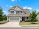 Charming two-story home with manicured lawn, gray siding, and attached two-car garage at 1305 Kings Grove Dr, York, SC 29745