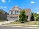 Charming two-story home with gray siding, well-maintained landscaping, and an attached garage, exudes curb appeal at 1305 Kings Grove Dr, York, SC 29745