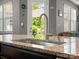 Kitchen island features a stainless steel sink and granite countertop, plus a view to the backyard at 1305 Kings Grove Dr, York, SC 29745
