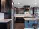 A kitchen featuring stainless steel appliances, granite countertops, dark cabinets, and wood flooring at 1305 Kings Grove Dr, York, SC 29745