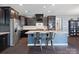 Modern kitchen boasts stainless steel appliances, granite countertops, dark cabinetry, and an island with seating at 1305 Kings Grove Dr, York, SC 29745
