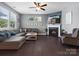 Inviting living room with hardwood floors, a cozy fireplace, and a sectional sofa at 1305 Kings Grove Dr, York, SC 29745
