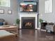 Inviting living room with hardwood floors, a cozy fireplace, and a sectional sofa at 1305 Kings Grove Dr, York, SC 29745