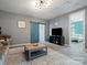 Well-lit living room with entertainment center, barn door and playful decor, offering both style and functionality at 1305 Kings Grove Dr, York, SC 29745