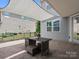 Tranquil covered patio featuring a cozy seating area, providing a perfect retreat for outdoor relaxation and entertainment at 1305 Kings Grove Dr, York, SC 29745