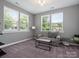 Bright and airy sitting room with many windows and a gray sofa at 1305 Kings Grove Dr, York, SC 29745