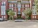 Brick apartment building featuring balconies and well-maintained landscaping at 1320 Fillmore Ave # 137, Charlotte, NC 28203