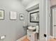 Cozy half bathroom includes a pedestal sink, framed mirror, and neutral paint at 1320 Fillmore Ave # 137, Charlotte, NC 28203