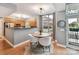 Bright dining area features a wooden table, white chairs, wood floors, and natural light from a large window at 1320 Fillmore Ave # 137, Charlotte, NC 28203