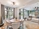 Cozy dining area with a round table, modern lighting, and a view into the living room at 1320 Fillmore Ave # 137, Charlotte, NC 28203