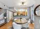 Dining area with hardwood floors, modern light fixture, and an open view of the kitchen at 1320 Fillmore Ave # 137, Charlotte, NC 28203