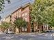 Brick condo building with mature trees, street parking and a glimpse of the surrounding neighborhood at 1320 Fillmore Ave # 137, Charlotte, NC 28203