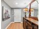 Hallway with wood floors, gray walls, and a wooden console table at 1320 Fillmore Ave # 137, Charlotte, NC 28203