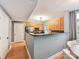 Well-lit kitchen boasts stainless steel appliances, wood cabinets, and a breakfast bar with dark countertops at 1320 Fillmore Ave # 137, Charlotte, NC 28203