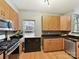 Open-concept kitchen features wood cabinets, stainless steel appliances, and dark countertops at 1320 Fillmore Ave # 137, Charlotte, NC 28203
