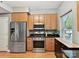 Modern kitchen features stainless steel appliances, wood cabinetry, and dark countertops at 1320 Fillmore Ave # 137, Charlotte, NC 28203