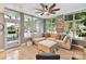 Cozy living room with hardwood floors, neutral sectional couch, and a modern ceiling fan at 1320 Fillmore Ave # 137, Charlotte, NC 28203