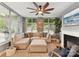 Bright living room features large windows, neutral decor, modern fan, and a cozy fireplace at 1320 Fillmore Ave # 137, Charlotte, NC 28203