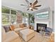 Comfortable living room with a fireplace, large windows and a comfortable sectional couch at 1320 Fillmore Ave # 137, Charlotte, NC 28203