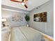Comfortable bedroom with a ceiling fan, mounted TV, hardwood floors, and neutral walls at 1320 Fillmore Ave # 137, Charlotte, NC 28203