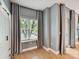 Light filled bedroom with hardwood floors, neutral paint and window with vertical blinds at 1320 Fillmore Ave # 137, Charlotte, NC 28203
