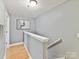 Hall staircase featuring wood floors, neutral wall paint and white trim and railing at 1320 Fillmore Ave # 137, Charlotte, NC 28203