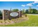Sullivan Farm entrance sign with brick pillars, an oval sign, landscaping, and green grass at 137 Wheeler Trl, Statesville, NC 28625