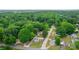 An aerial view shows this home nestled in a neighborhood surrounded by a lush forest at 1415 Midlake Rd, Kannapolis, NC 28083