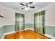 Cozy bedroom with hardwood floors, ceiling fan and two windows with green curtains at 1415 Midlake Rd, Kannapolis, NC 28083