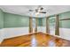 Well-lit bedroom featuring hardwood floors, two windows, and fresh paint at 1415 Midlake Rd, Kannapolis, NC 28083