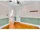 Bedroom with hardwood floors, and a neutral color scheme accented by green wainscoting and white trim at 1415 Midlake Rd, Kannapolis, NC 28083