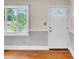 Bright entryway with hardwood floors, white door, and natural light from a window with blinds at 1415 Midlake Rd, Kannapolis, NC 28083