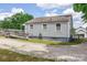 Exterior view of a home with a wooden ramp, vinyl siding, gravel driveway, and well-maintained lawn at 1415 Midlake Rd, Kannapolis, NC 28083