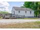 View of a home's exterior with vinyl siding, wooden ramp, and a gravel driveway at 1415 Midlake Rd, Kannapolis, NC 28083