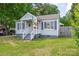 Charming one-story home with a welcoming front porch, blue shutters, and well-maintained lawn at 1415 Midlake Rd, Kannapolis, NC 28083