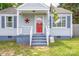 Charming single-story home with a inviting front porch and a vibrant red front door at 1415 Midlake Rd, Kannapolis, NC 28083
