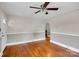Spacious living room featuring hardwood floors, neutral walls, and an open archway at 1415 Midlake Rd, Kannapolis, NC 28083