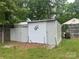 A shed is in the backyard, with a cow statue and a gardening cart at 1415 Midlake Rd, Kannapolis, NC 28083