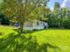 Well-maintained single-story home with a spacious lawn and mature trees at 142 Sandra Dr, Statesville, NC 28625