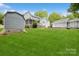 Large backyard featuring a house, detached garage, a covered structure and manicured lawn at 16612 Grapperhall Dr, Huntersville, NC 28078