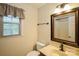 Bathroom featuring a framed mirror, vanity, and natural light at 16612 Grapperhall Dr, Huntersville, NC 28078