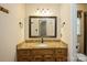 Bathroom vanity with wood cabinets, granite countertop, and large mirror at 16612 Grapperhall Dr, Huntersville, NC 28078