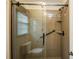 Walk-in shower stall with glass doors and window for natural light at 16612 Grapperhall Dr, Huntersville, NC 28078