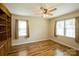 Bedroom with hardwood floors, ceiling fan, and natural light from the windows at 16612 Grapperhall Dr, Huntersville, NC 28078