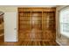 Bedroom with wood floors, built in shelving, and large window at 16612 Grapperhall Dr, Huntersville, NC 28078