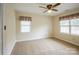 Bedroom with carpet, ceiling fan, and two large windows at 16612 Grapperhall Dr, Huntersville, NC 28078